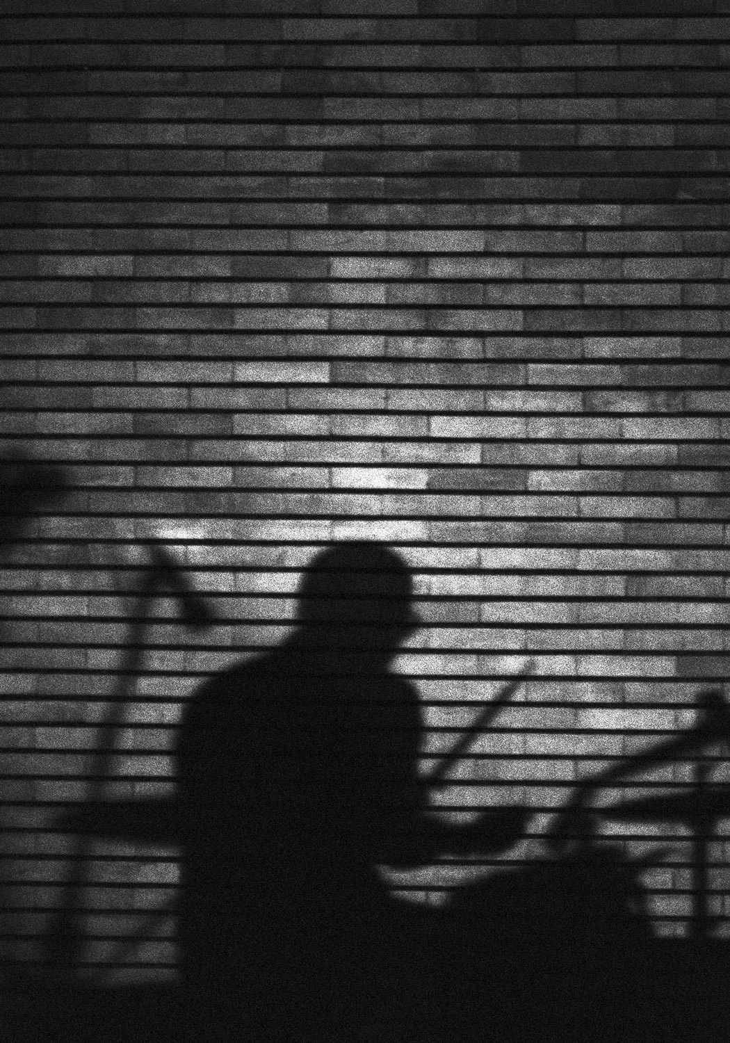 Drummer shadow on a brick wall