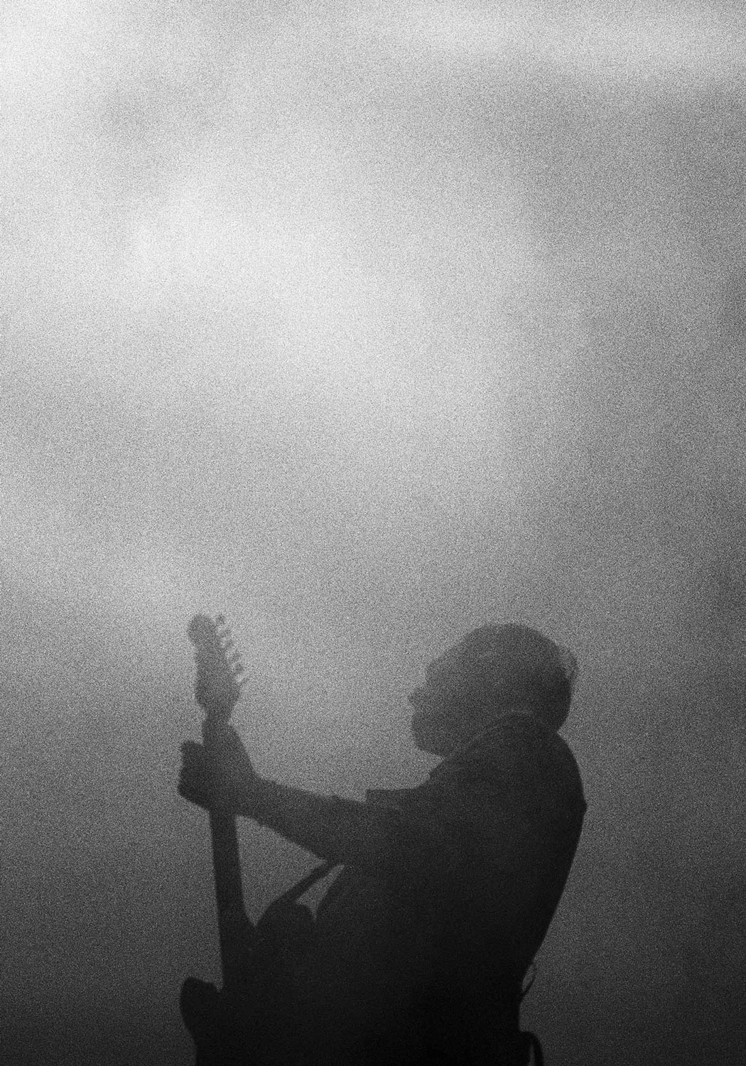 Guitarist playing music inside the fog