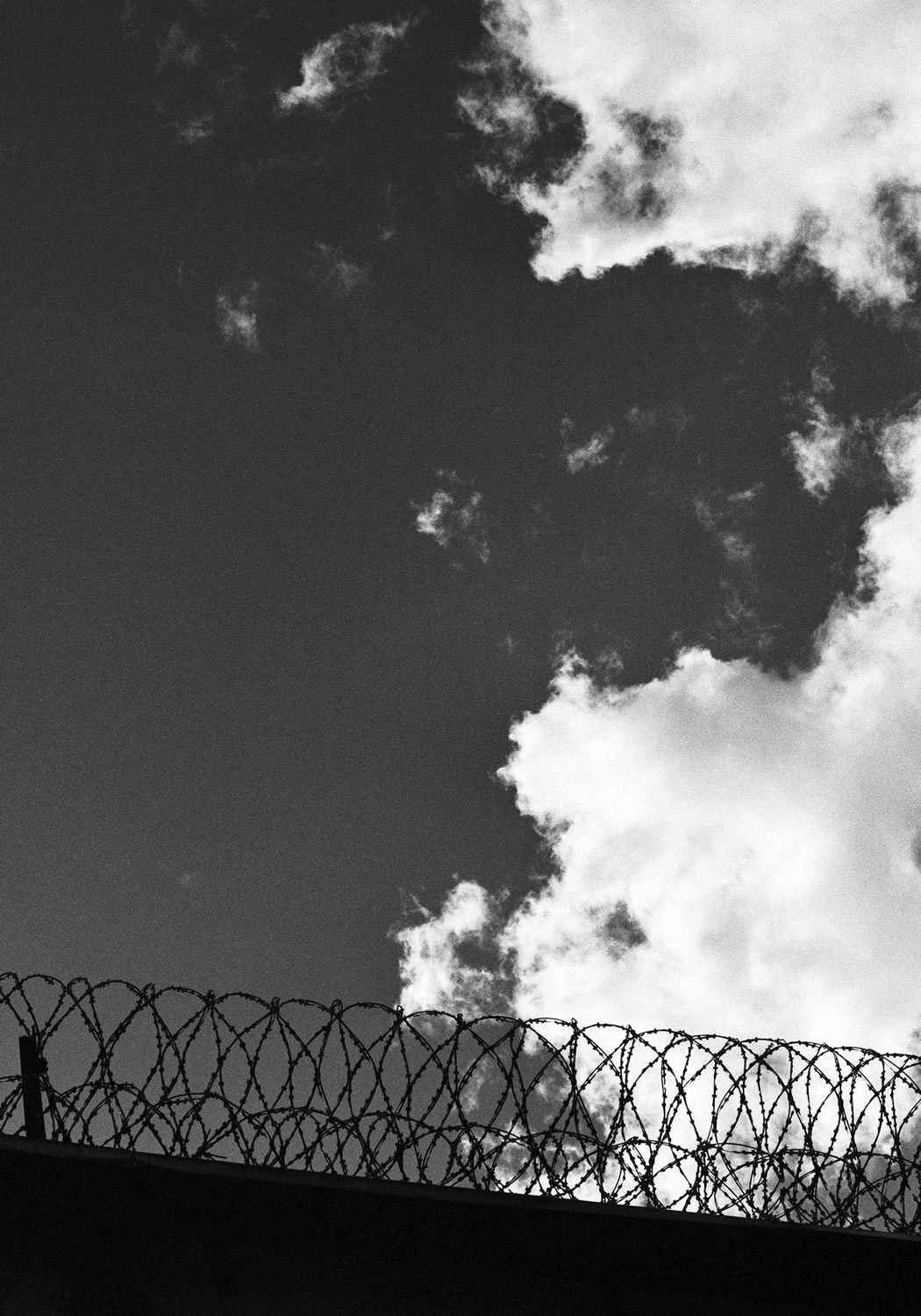 Prison fence with a great portion of cloudy sky